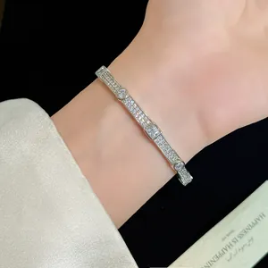 Elegant 18K gold plated double-row zircon bangle bracelet shown on woman's wrist