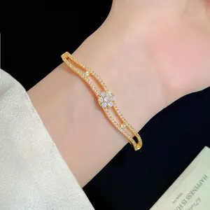Elegant 18K gold plated double-layered zircon flower bracelet shown on a woman's wrist