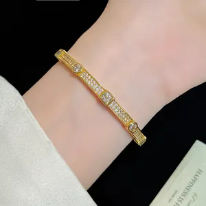 Close-up of elegant 18K gold plated bracelet with sparkling square zircons