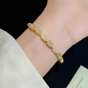 Close-up of elegant 18K gold plated bracelet with rectangular pavé stones on wrist
