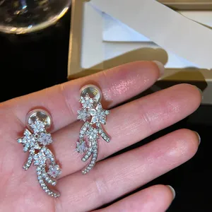 Close-up of sparkling zircon meteor star clip-on earrings with mosquito coil back