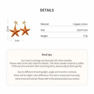 Detailed view of orange enamel starfish earrings with material and size information
