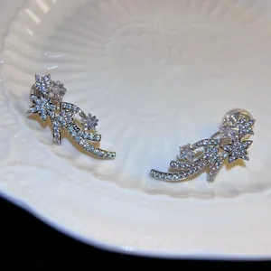 Exquisite detail of silver shooting star ear clips featuring shimmering cubic zirconia