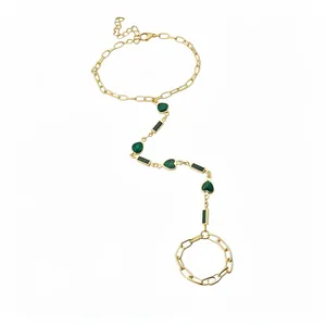 Vintage gold-toned chain finger bracelet featuring green heart and bar resin charm inlays