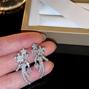 Macro detail showing silver-tone meteor ear clips paved with high-quality cubic zirconia