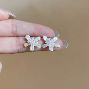 Elegant white oil-drop flower stud earrings with shimmering crystal center details for women