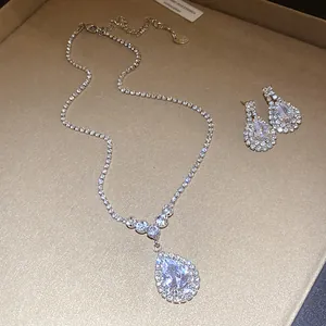 Detailed view of silver waterdrop pendant necklace and matching crystal earrings set