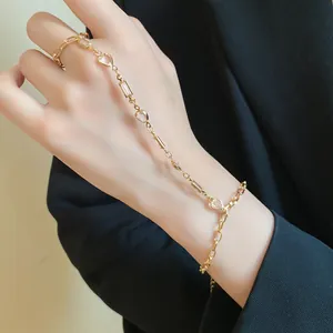 Detail of a vintage-style gold ring bracelet with resin heart charms on a hand