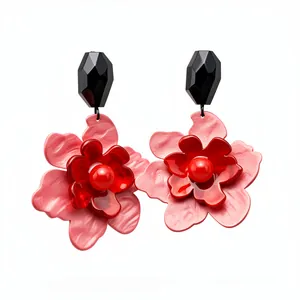 Elegant pink and red acrylic flower pendant earrings with black beads on a white background