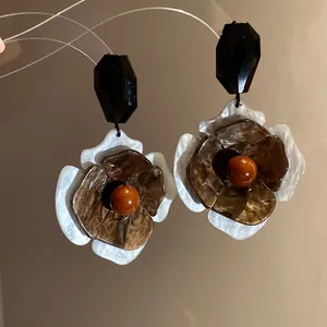 Detailed view of vintage acrylic flower drop earrings with marbled texture petals