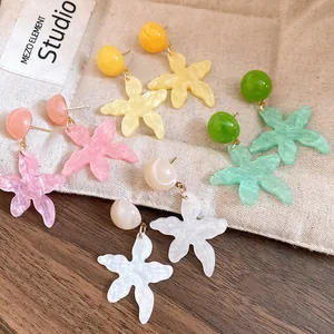 Detailed close-up of resin starfish drop earrings in multiple summer pastel colors