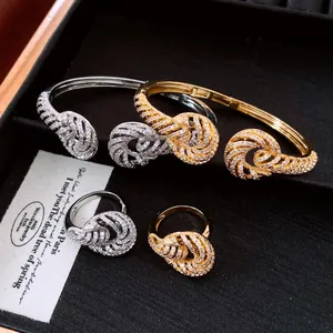 Detail of 18K gold plated zircon twisted knot bangle and matching ring set