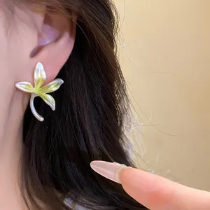 Detailed macro shot of an orchid flower earring featuring a fresh green enamel finish