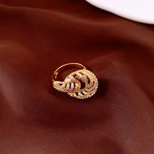 Detail shot of elegant 18K gold plated twisted ring encrusted with zircon stones