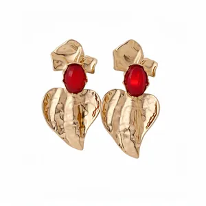 Elegant gold textured heart drop earrings featuring red resin stones and bow accent details