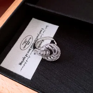 Detailed macro view of a silver-toned twisted ring with sparkling pavé zircon stones