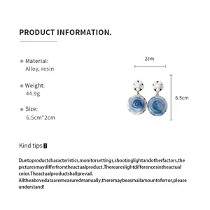Blue resin rose earrings with white beads and size measurements information