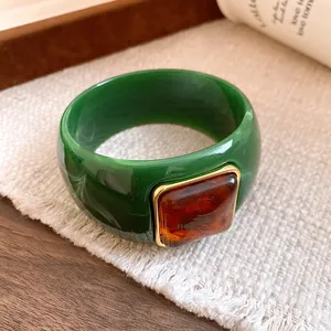 Elegant green acrylic bangle bracelet featuring a vintage square amber resin inlay detail.