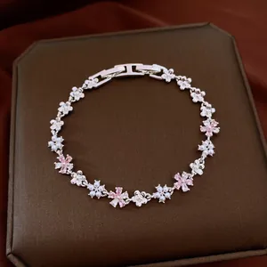 Detailed view of elegant floral silver bracelet with pink zircons and small pearls