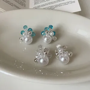 Macro view of fresh sweet flower pearl stud earrings with zircon and silver beads