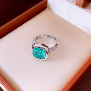 Détail d'une bague en argent avec une pierre verte carrée dans son écrin à bijoux