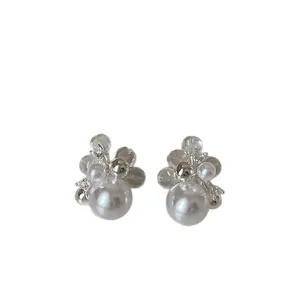 Elegant pearl stud earrings featuring clear flower petals and shiny zircon accents