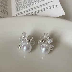 Detailed macro view of elegant floral pearl earrings accented with sparkling zirconia stones