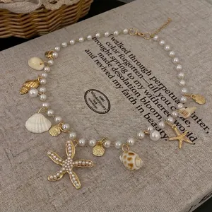 Elegant vintage baroque pearl necklace featuring gold sea shell and starfish charms.