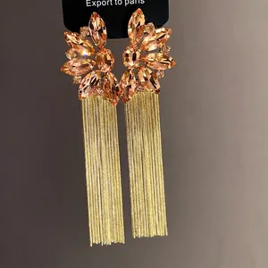 Elegant champagne crystal flower earrings with long gold tassel drops for women.