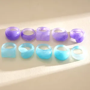Detailed view of assorted resin marble rings in vibrant purple and light blue tones