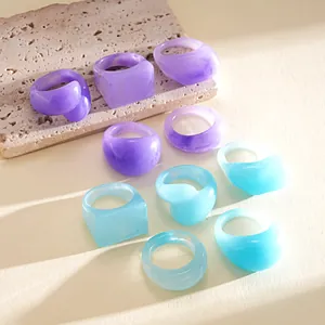 Detailed macro view showing marbled purple and blue resin rings on a stone slab base.
