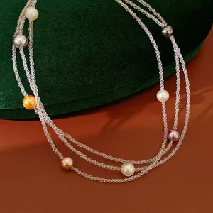 Dettaglio di una collana a più strati con perle colorate eleganti su sfondo velluto