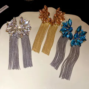Detailed view of luxury rhinestone flower earrings with long metal tassels in three colors