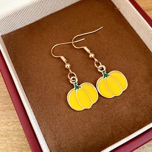 Exquisite yellow pumpkin dangle earrings with gold finish in a luxury red jewelry box