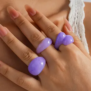 Detailed close-up showing purple marble resin rings with unique geometric and heart shapes