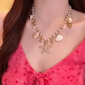 Close-up of vintage pearl necklace with shell and starfish charms on a model