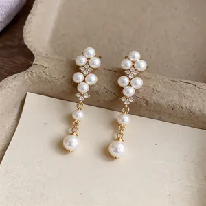 Elegant French-style gold drop earrings featuring lustrous pearls and sparkling zircons