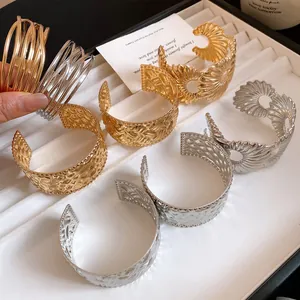 Detailansicht verschiedener texturierter Metall-Armreifen in Gold- und Silberoptik