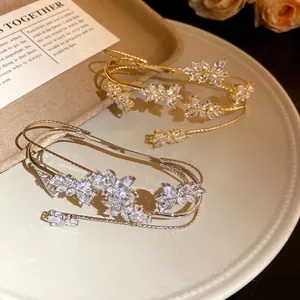 Detailed view of elegant gold and silver bangles with sparkling wheat ear zircon design