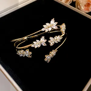 Close-up detail of sparkling zircon wheat ear motif on elegant gold-toned bangle