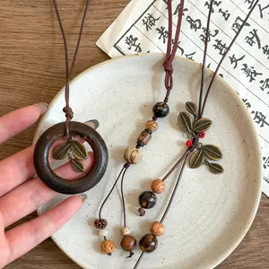 Detailed macro view of vintage ethnic style long necklace with wood ring and bodhi seeds