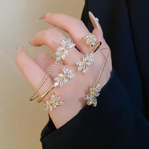 Close-up detail of elegant zircon wheat ear pattern on a gold-plated fashion bracelet