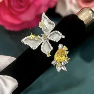 Luxury butterfly open ring with yellow zircon and shell inlay displayed on black velvet