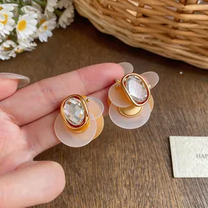 Detail view of elegant 18k gold plated geometric stud earrings featuring clear zircon stones