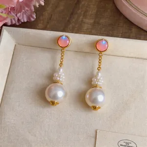 French elegant pearl drop earrings with iridescent pink studs and gold chain detail