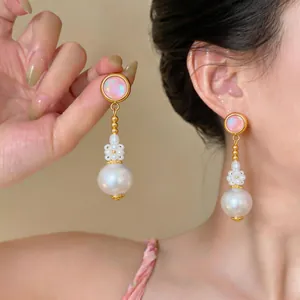 Detail view of elegant French style pink opal and large white pearl dangle earrings