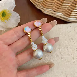 Elegant French style iridescent and grey pearl drop earrings close-up detail view