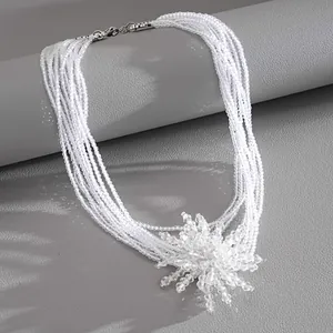 Close-up of an elegant multi-strand clear crystal necklace with a flower pendant