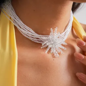 Detail view of a multi-layer crystal bead choker necklace with a snowflake flower