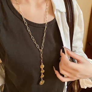 Elegant gold paperclip chain necklace featuring three vintage coin pendants for women